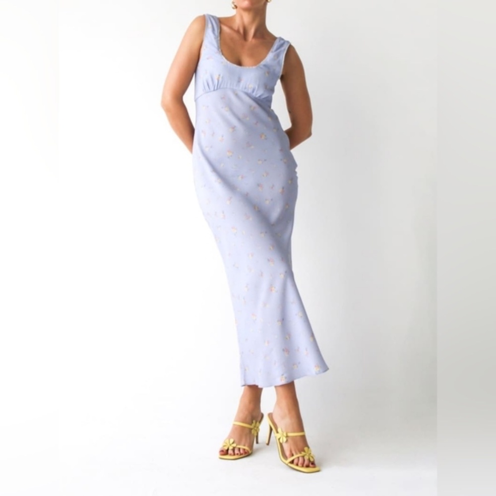 This vintage-inspired slip dress exudes elegance with its silky texture and deli